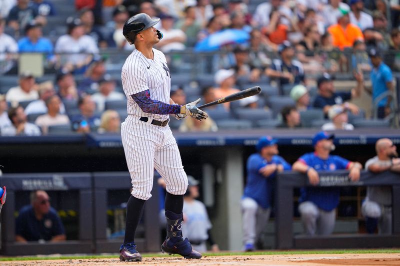 Jul 8, 2023; Bronx, New York, USA; New York Yankees right fielder Giancarlo Stanton (27) watches his home run against the Chicago Cubs during the first inning at Yankee Stadium. Mandatory Credit: Gregory Fisher-USA TODAY Sports