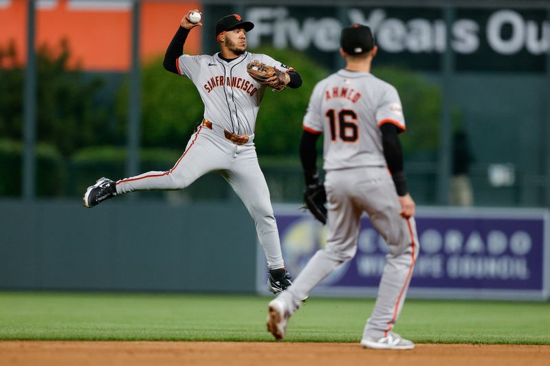 May 7, 2024; Denver, Colorado, USA; San Francisco Giants second baseman Thairo Estrada (39) makes a throw to first as shortstop Nick Ahmed (16) looks on in the ninth inning against the Colorado Rockies at Coors Field. Mandatory Credit: Isaiah J. Downing-USA TODAY Sports