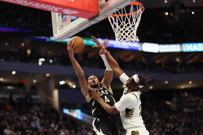 MILWAUKEE, WISCONSIN - NOVEMBER 22: Giannis Antetokounmpo #34 of the Milwaukee Bucks works against Myles Turner #33 of the Indiana Pacers during the second half of a game in the NBA Emirates Cup at Fiserv Forum on November 22, 2024 in Milwaukee, Wisconsin. NOTE TO USER: User expressly acknowledges and agrees that, by downloading and or using this photograph, User is consenting to the terms and conditions of the Getty Images License Agreement. (Photo by Stacy Revere/Getty Images)