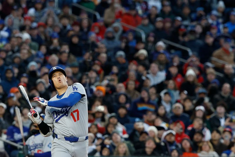 Apr 8, 2025; Washington, District of Columbia, USA; Los Angeles Dodgers two-way player Shohei Ohtani (17) reacts after fouling off a pitch against the Washington Nationals during the third inning at Nationals Park. Mandatory Credit: Geoff Burke-Imagn Images