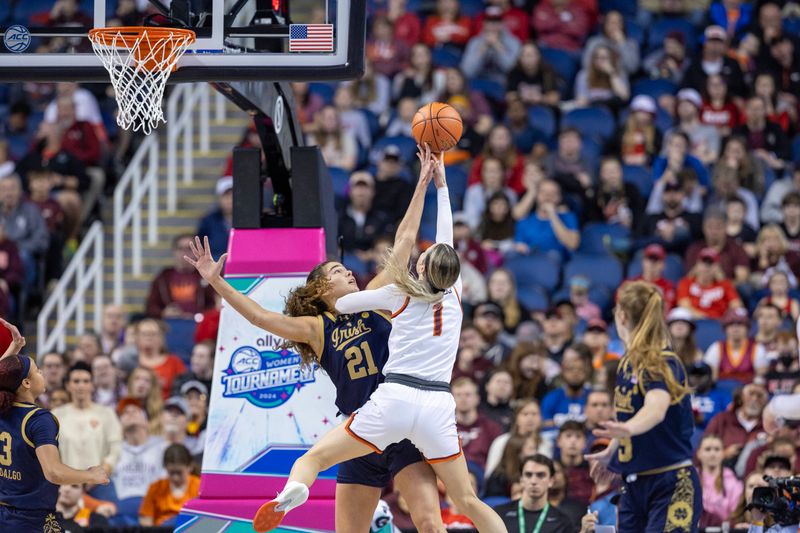 Mar 9, 2024; Greensboro, NC, USA; Notre Dame Fighting Irish forward Maddy Westbeld (21) blocks the attempted sho of Virginia Tech Hokies guard Carleigh Wenzel (1) during the second half at Greensboro Coliseum. Mandatory Credit: David Yeazell-USA TODAY Sports