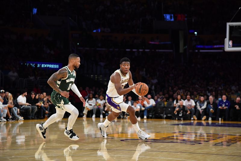 LOS ANGELES, CA - OCTOBER 15: Rui Hachimura #28 of the Los Angeles Lakers drives to the basket against defender Damian Lillard #0 of the Milwaukee Bucks during the preseason game on October 15, 2023 at Crypto.Com Arena in Los Angeles, California. NOTE TO USER: User expressly acknowledges and agrees that, by downloading and/or using this Photograph, user is consenting to the terms and conditions of the Getty Images License Agreement. Mandatory Copyright Notice: Copyright 2023 NBAE (Photo by Juan Ocampo/NBAE via Getty Images)