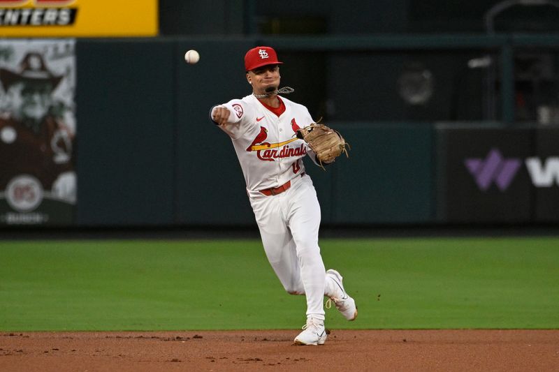 Sep 6, 2024; St. Louis, Missouri, USA; St. Louis Cardinals shortstop Masyn Winn (0) throws to first for an out against the Seattle Mariners in the first inning at Busch Stadium. Mandatory Credit: Joe Puetz-Imagn Images