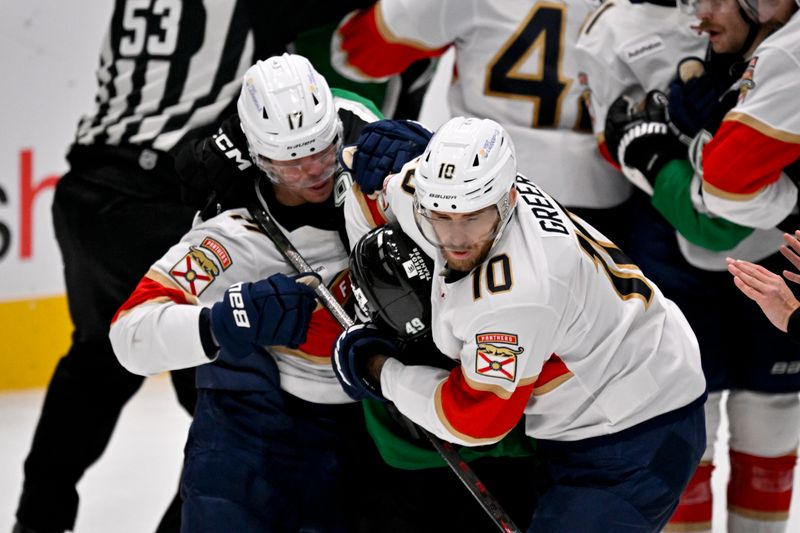 Dec 13, 2025; Dallas, Texas, USA; Florida Panthers center Evan Rodrigues (17) and left wing A.J. Greer (10) fight with Dallas Stars center Justin Hryckowian (49) during the third period at the American Airlines Center. Mandatory Credit: Jerome Miron-Imagn Images