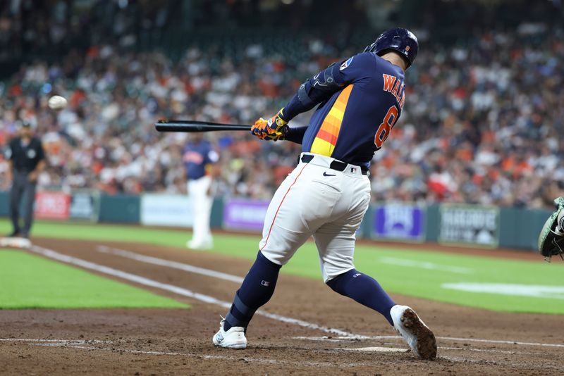 May 25, 2025; Houston, Texas, USA; Houston Astros first baseman Christian Walker (8) hits an RBI single during the third inning against the Seattle Mariners at Daikin Park. Mandatory Credit: Troy Taormina-Imagn Images