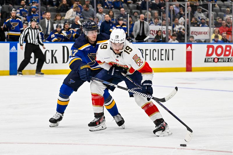 Jan 9, 2024; St. Louis, Missouri, USA;  Florida Panthers left wing Matthew Tkachuk (19) controls the puck as St. Louis Blues defenseman Torey Krug (47) defends during the first period at Enterprise Center. Mandatory Credit: Jeff Curry-USA TODAY Sports