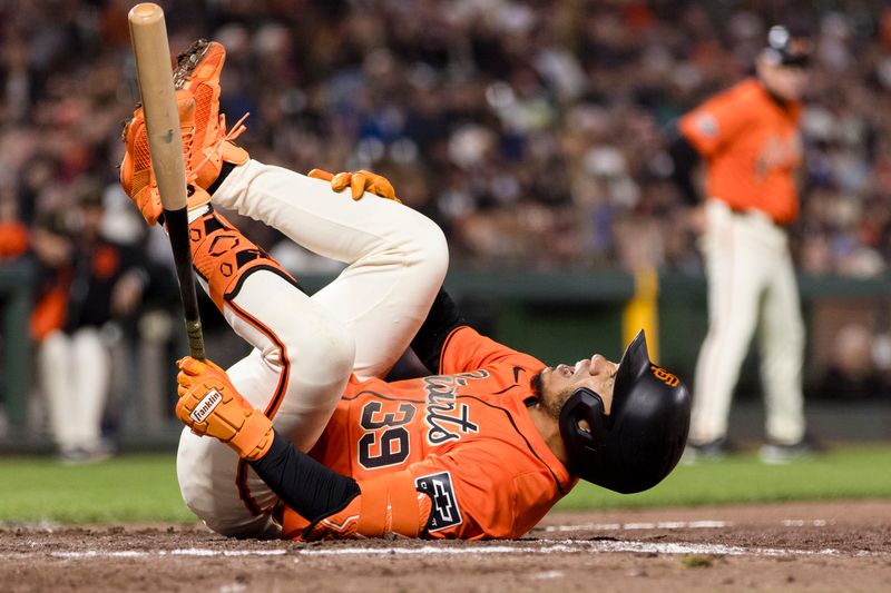 May 17, 2024; San Francisco, California, USA; San Francisco Giants second baseman Thairo Estrada (39) falls to the ground after being hit by a foul ball during the fifth inning of the game against the Colorado Rockies at Oracle Park. Mandatory Credit: John Hefti-USA TODAY Sports