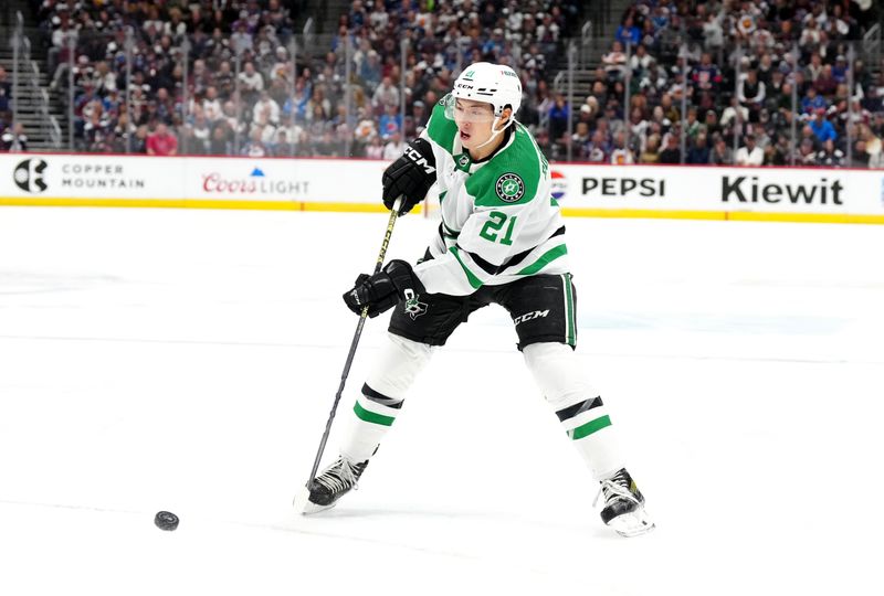 Apr 7, 2024; Denver, Colorado, USA; Dallas Stars left wing Jason Robertson (21) shoots the puck in the first period against the Dallas Stars at Ball Arena. Mandatory Credit: Ron Chenoy-USA TODAY Sports