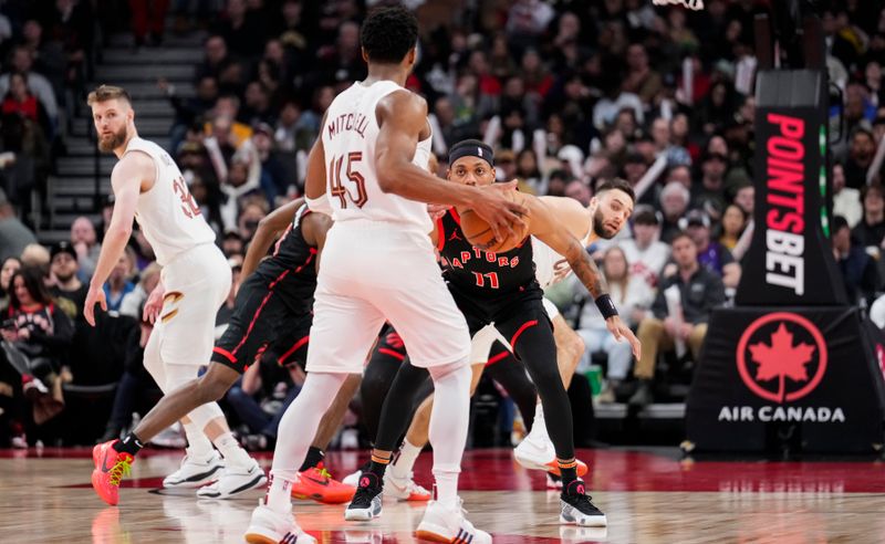 TORONTO, ON - FEBRUARY 10: Bruce Brown #11 of the Toronto Raptors guards Donovan Mitchell #45 of the Cleveland Cavaliers during the second half of their basketball game at the Scotiabank Arena on February 10, 2024 in Toronto, Ontario, Canada. NOTE TO USER: User expressly acknowledges and agrees that, by downloading and/or using this Photograph, user is consenting to the terms and conditions of the Getty Images License Agreement. (Photo by Mark Blinch/Getty Images)