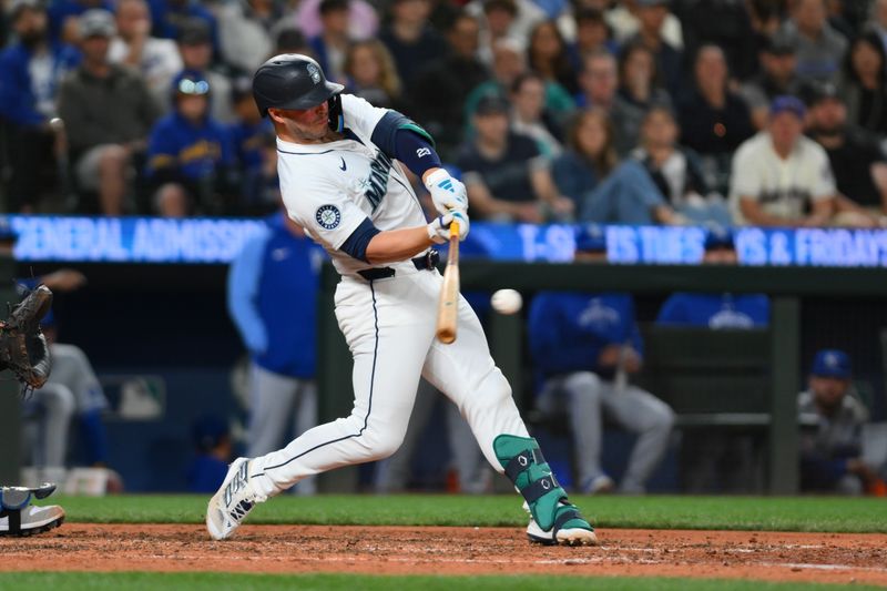 May 14, 2024; Seattle, Washington, USA; Seattle Mariners first baseman Ty France (23) hits a single against the Kansas City Royals during the eighth inning at T-Mobile Park. Mandatory Credit: Steven Bisig-USA TODAY Sports
