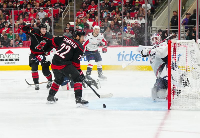 May 10, 2025; Raleigh, North Carolina, USA; Carolina Hurricanes left wing Eric Robinson (50) scores a goal past Washington Capitals goaltender Logan Thompson (48) during the third period in game three of the second round of the 2025 Stanley Cup Playoffs at Lenovo Center. Mandatory Credit: James Guillory-Imagn Images