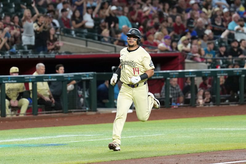 Jul 30, 2024; Phoenix, Arizona, USA; Arizona Diamondbacks catcher Gabriel Moreno (14) scores a run against the Washington Nationals during the second inning at Chase Field. Mandatory Credit: Joe Camporeale-USA TODAY Sports