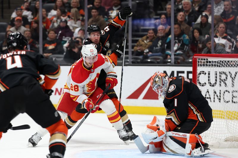 Dec 21, 2023; Anaheim, California, USA;  Calgary Flames center Elias Lindholm (28) shoots the puck against Anaheim Ducks goaltender Lukas Dostal (1) during the first period at Honda Center. Mandatory Credit: Kiyoshi Mio-USA TODAY Sports