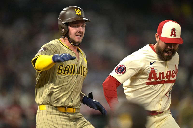 Jun 5, 2024; Anaheim, California, USA;  Los Angeles Angels relief pitcher Matt Moore (55) tags San Diego Padres first baseman Jake Cronenworth (9) out as they run to first base in the ninth inning at Angel Stadium. Mandatory Credit: Jayne Kamin-Oncea-USA TODAY Sports