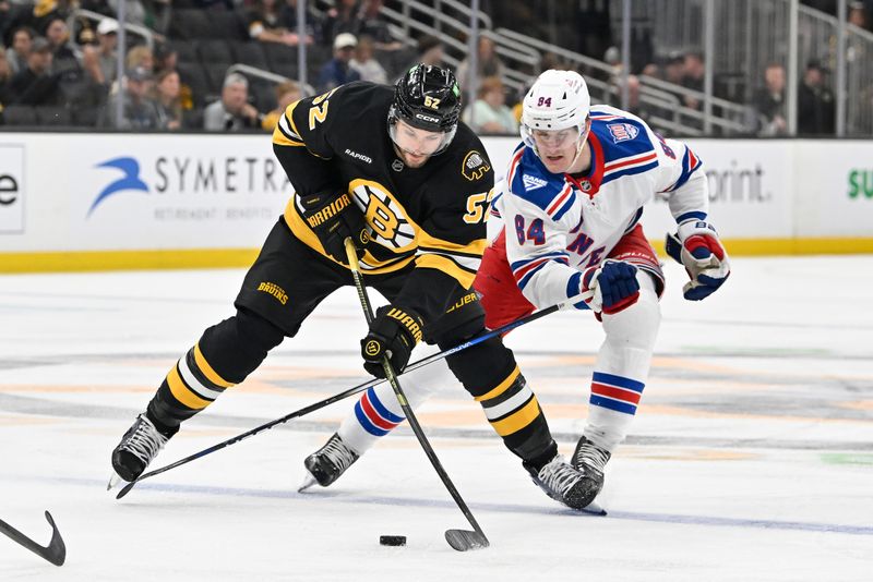 Oct 4, 2025; Boston, Massachusetts, USA; New York Rangers center Adam Edstrom (84) reaches in to check the stick of Boston Bruins center Sean Kuraly (52) during the first period at TD Garden. Mandatory Credit: Eric Canha-Imagn Images
