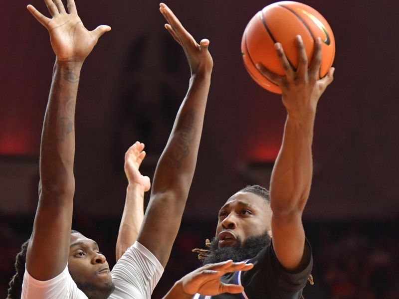 Nov 6, 2023; Champaign, Illinois, USA; Eastern Illinois Panthers guard Jaylin Gibson (24) drives to the basket as Illinois Fighting Illini forward Dain Dainja (42) defends during the second half at State Farm Center. Mandatory Credit: Ron Johnson-USA TODAY Sports