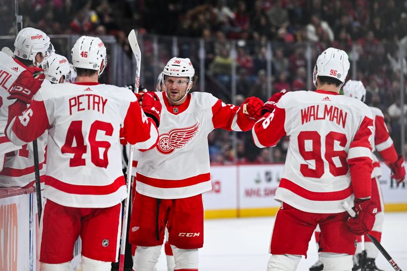 Dec 2, 2023; Montreal, Quebec, CAN; Detroit Red Wings right wing Christian Fischer (36) celebrates his goal against the Montreal Canadiens with defenseman Jeff Petry and defenseman Jake Walman near the bench during the first period at Bell Centre. Mandatory Credit: David Kirouac-USA TODAY Sports