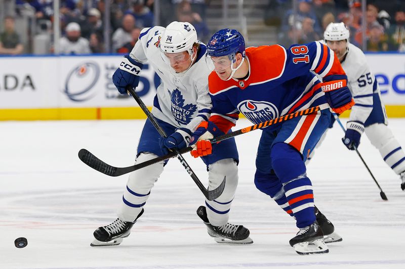 Jan 16, 2024; Edmonton, Alberta, CAN; Edmonton Oilers forward Zach Hyman (18) and Toronto Maple Leafs forward Bobby McMann (74) battle for a loose puck during the second period at Rogers Place. Mandatory Credit: Perry Nelson-USA TODAY Sports