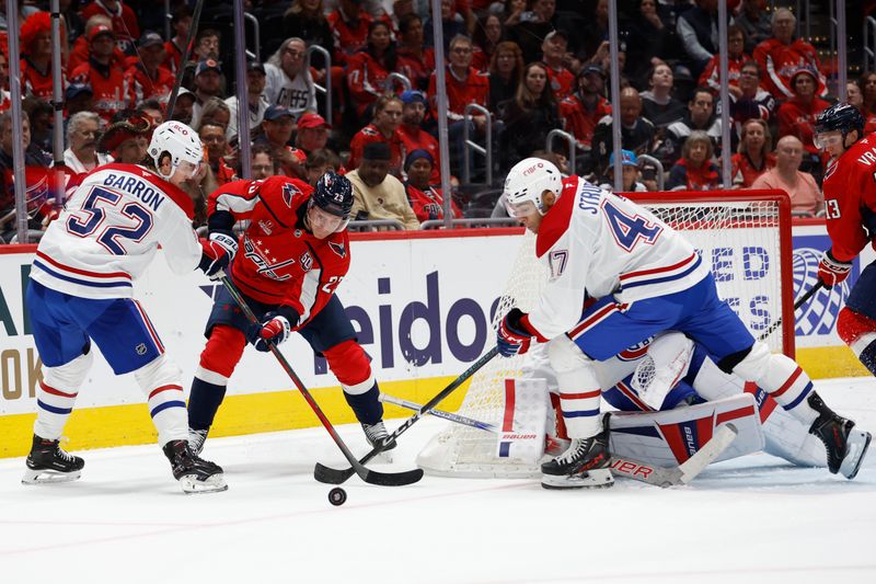 Oct 31, 2024; Washington, District of Columbia, USA; Washington Capitals center Michael Sgarbossa (23), Canadiens defenseman Justin Barron (52), and Canadiens defenseman Jayden Struble (47) battle for the puck in the first period at Capital One Arena. Mandatory Credit: Geoff Burke-Imagn Images