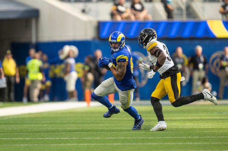 Los Angeles Rams tight end Tyler Higbee (89) runs with the ball as Pittsburgh Steelers safety Keanu Neal (31) chases during an NFL football game, Sunday, Oct. 22, 2023, in Inglewood, Calif. (AP Photo/Kyusung Gong)