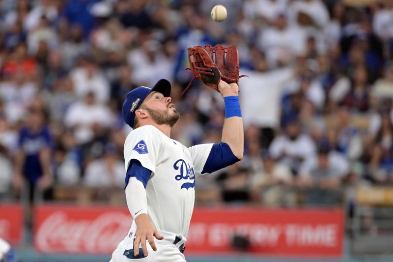 Oct 11, 2024; Los Angeles, California, USA; Los Angeles Dodgers second baseman Gavin Lux (9) makes a catch against San Diego Padres outfielder David Peralta (not pictured) in the fifth inning during game five of the NLDS for the 2024 MLB Playoffs at Dodger Stadium. Mandatory Credit: Jayne Kamin-Oncea-Imagn Images