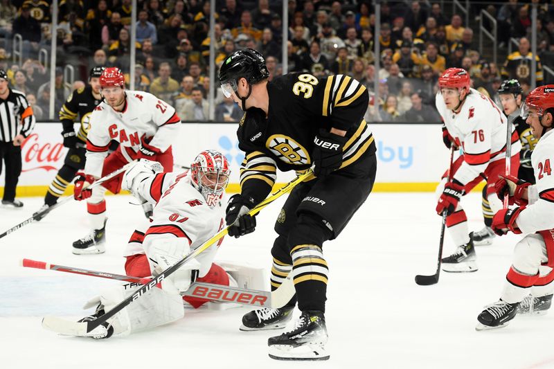 Apr 9, 2024; Boston, Massachusetts, USA; Carolina Hurricanes goaltender Pyotr Kochetkov (52) makes a save on Boston Bruins center Morgan Geekie (39) during the first period at TD Garden. Mandatory Credit: Bob DeChiara-USA TODAY Sports