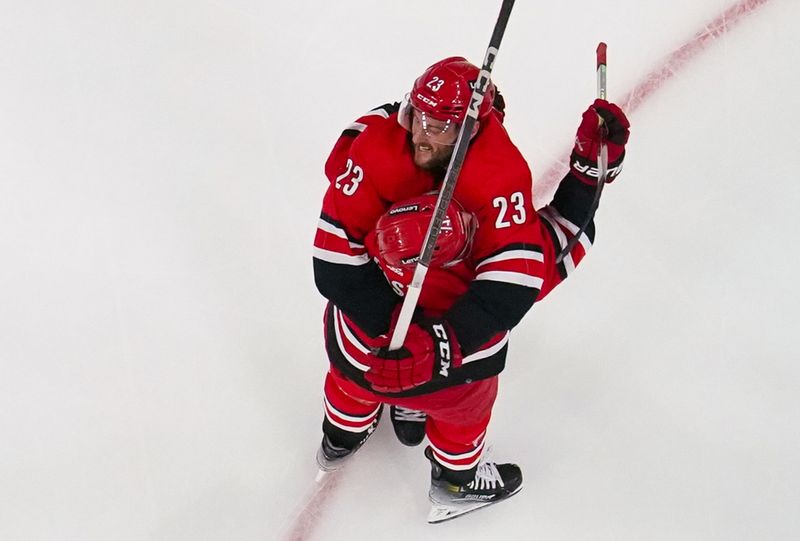 Dec 28, 2023; Raleigh, North Carolina, USA; Carolina Hurricanes right wing Jesper Fast (71) is congratulated by Carolina Hurricanes right wing Stefan Noesen (23) after his goal against the Montreal Canadiens during the second period at PNC Arena. Mandatory Credit: James Guillory-USA TODAY Sports