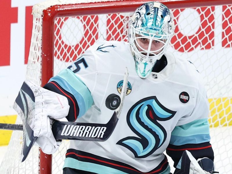 Jan 16, 2025; Winnipeg, Manitoba, CAN; Seattle Kraken goaltender Joey Daccord (35) bats away the puck against the Winnipeg Jets in the third period at Canada Life Centre. Mandatory Credit: James Carey Lauder-Imagn Images