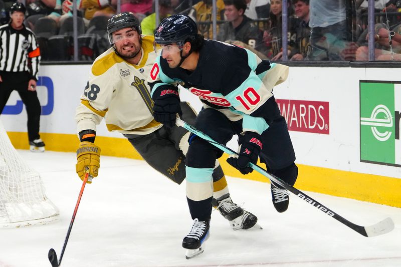 Mar 21, 2024; Las Vegas, Nevada, USA; Seattle Kraken center Matty Beniers (10) skates ahead of Vegas Golden Knights left wing William Carrier (28) during the second period at T-Mobile Arena. Mandatory Credit: Stephen R. Sylvanie-USA TODAY Sports