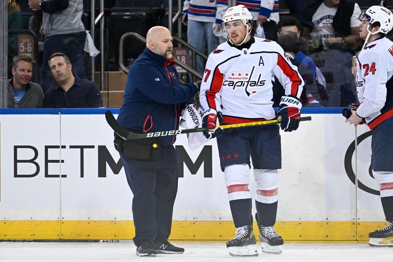 Apr 23, 2024; New York, New York, USA;  Washington Capitals right wing T.J. Oshie (77) helped off the ice by a trainer after the game during the third period in game two of the first round of the 2024 Stanley Cup Playoffs at Madison Square Garden. Mandatory Credit: Dennis Schneidler-USA TODAY Sports