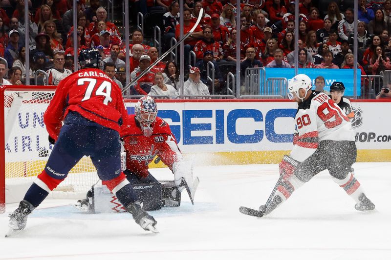 Oct 12, 2024; Washington, District of Columbia, USA; Washington Capitals goaltender Charlie Lindgren (79) makes a save on New Jersey Devils left wing Tomas Tatar (90) as Capitals defenseman John Carlson (74) defends in the second period at Capital One Arena. Mandatory Credit: Geoff Burke-Imagn Images