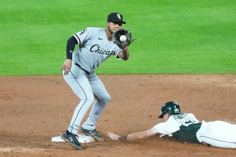 Aug 19, 2023; Denver, Colorado, USA; Colorado Rockies right fielder Nolan Jones (22) beats out the tag of Chicago White Sox second baseman Lenyn Sosa (50) in the eighth inning at Coors Field. Mandatory Credit: Ron Chenoy-USA TODAY Sports