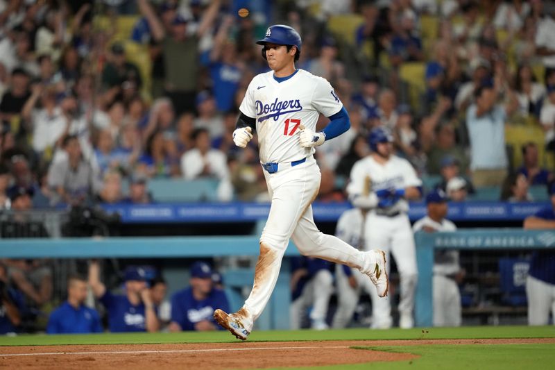 Aug 21, 2024; Los Angeles, California, USA; Los Angeles Dodgers designated hitter Shohei Ohtani (17) scores in the fifth inning against the Seattle Mariners at Dodger Stadium. Mandatory Credit: Kirby Lee-USA TODAY Sports