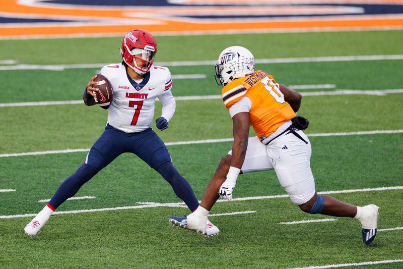 Nov 25, 2023; El Paso, Texas, USA; No. 22 Liberty Flames quarterback Kaidon Salter (7) tries to evade a UTEP Miners defensive end Maurice Westmoreland (0) during the first half at Sun Bowl Stadium. Mandatory Credit: Ivan Pierre Aguirre-USA TODAY Sports