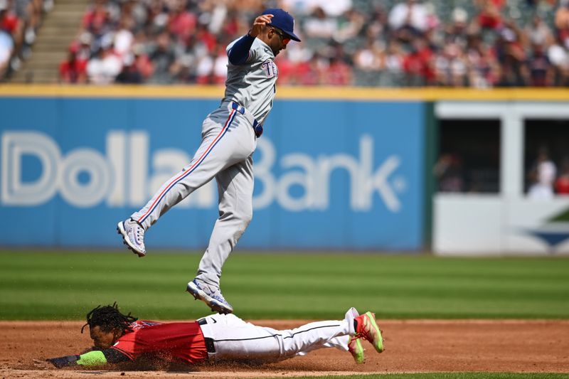 Aug 25, 2024; Cleveland, Ohio, USA; Cleveland Guardians third baseman Jose Ramirez (11) steals second base under exas Rangers second baseman Marcus Semien (2) during the third inning at Progressive Field. Mandatory Credit: Ken Blaze-USA TODAY Sports