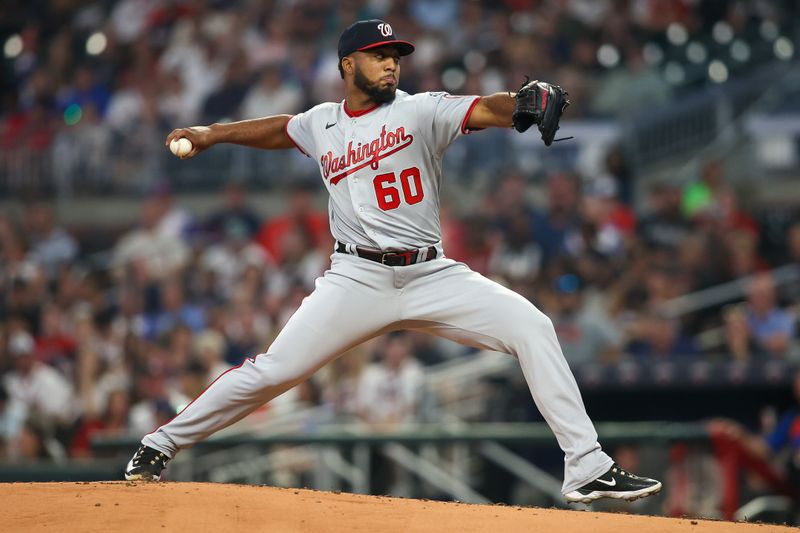 Sep 30, 2023; Atlanta, Georgia, USA; Washington Nationals starting pitcher Joan Adon (60) throws against the Atlanta Braves in the first inning at Truist Park. Mandatory Credit: Brett Davis-USA TODAY Sports