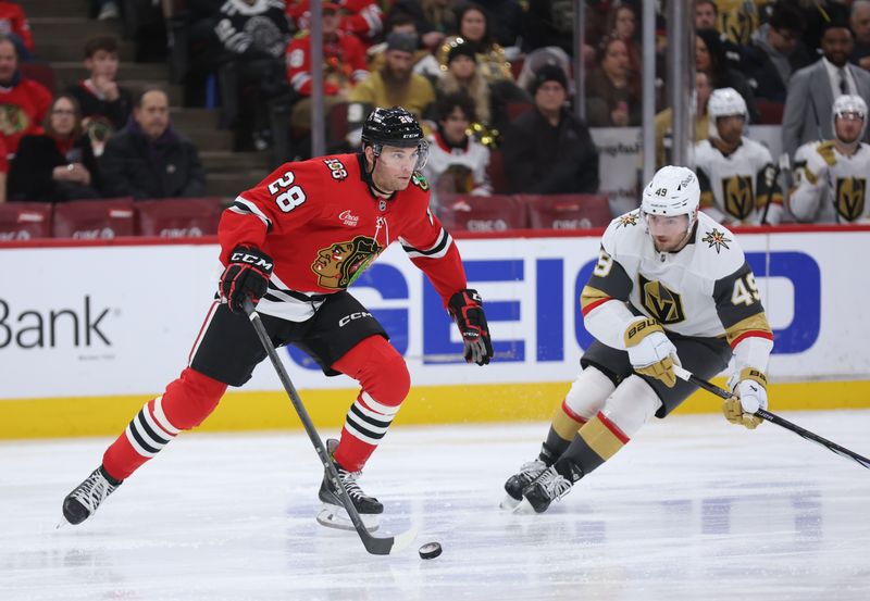 Jan 4, 2026; Chicago, Illinois, USA; Chicago Blackhawks left wing Andre Burakovsky (28) and Vegas Golden Knights left wing Ivan Barbashev (49) battle for control of the puck during the second period at United Center. Mandatory Credit: Talia Sprague-Imagn Images