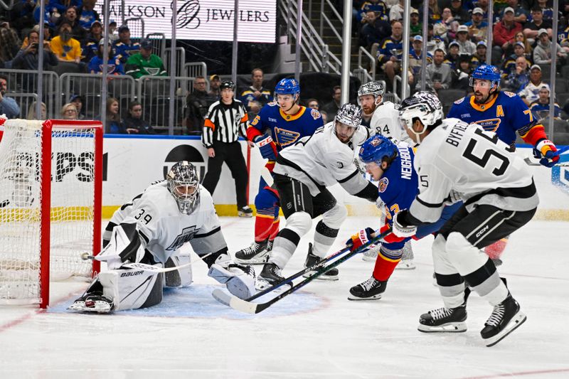 Mar 13, 2024; St. Louis, Missouri, USA;  St. Louis Blues left wing Jake Neighbours (63) shoots and scores against Los Angeles Kings goaltender Cam Talbot (39) during the second period at Enterprise Center. Mandatory Credit: Jeff Curry-USA TODAY Sports