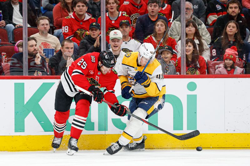 Mar 22, 2026; Chicago, Illinois, USA; Chicago Blackhawks center Dominic Toninato (25) battles for the puck with Nashville Predators center Fedor Svechkov (40) during the first period at United Center. Mandatory Credit: Kamil Krzaczynski-Imagn Images