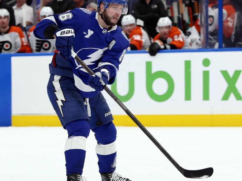 Nov 7, 2024; Tampa, Florida, USA; Tampa Bay Lightning right wing Nikita Kucherov (86) passes the puck against the Philadelphia Flyers during the third period at Amalie Arena. Mandatory Credit: Kim Klement Neitzel-Imagn Images