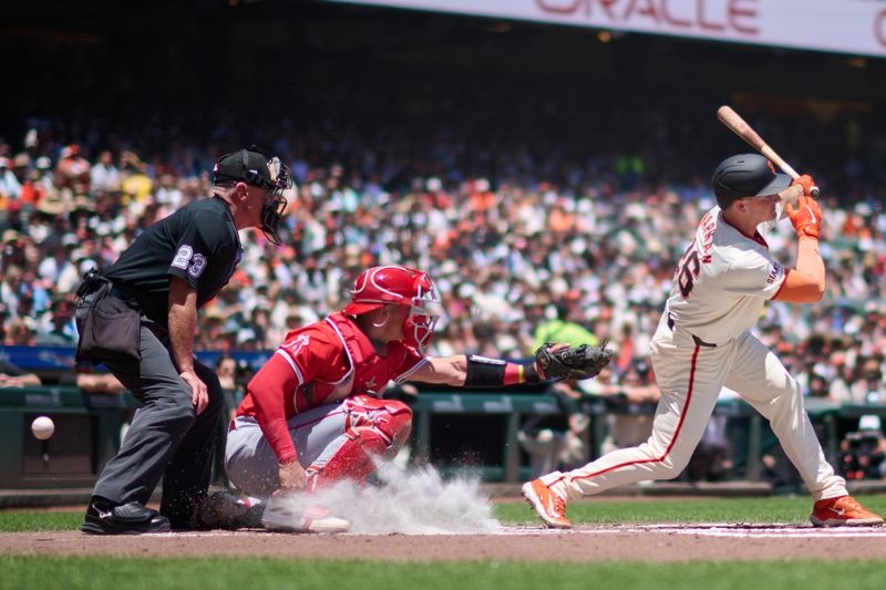 Jun 15, 2024; San Francisco, California, USA; San Francisco Giants infielder Matt Chapman (26) fouls off a pitch against Los Angeles Angels catcher Logan O'Hoppe (14) and home plate umpire Lance Barksdale (23) watches the play during the first inning at Oracle Park. Mandatory Credit: Robert Edwards-USA TODAY Sports