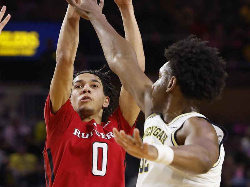 Feb 3, 2024; Ann Arbor, Michigan, USA;  Rutgers Scarlet Knights guard Derek Simpson (0) shoots on Michigan Wolverines forward Tarris Reed Jr. (32) in the second half at Crisler Center. Mandatory Credit: Rick Osentoski-USA TODAY Sports