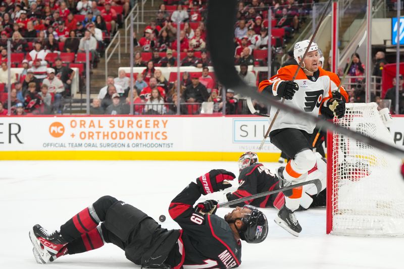 Oct 11, 2025; Raleigh, North Carolina, USA;  Philadelphia Flyers right wing Bobby Brink (10) overtime goal is disallowed after goaltender interference against Carolina Hurricanes goaltender Frederik Andersen (31) at Lenovo Center. Mandatory Credit: James Guillory-Imagn Images