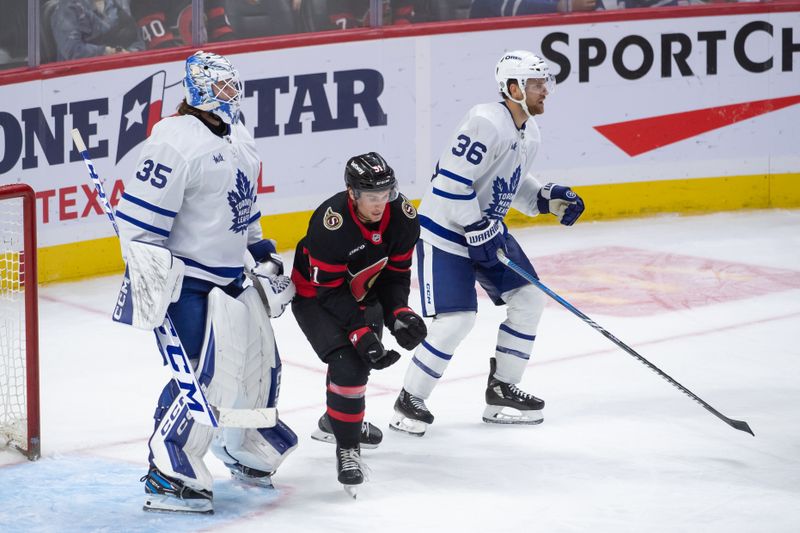 Sep 24, 2024; Ottawa, Ontario, CAN; Ottawa Senators left wing Cole Reinhardt (51) loses his stick after battling with Toronto Maple Leafs defenseman Dakota Mermis (36) in the third period at the Canadian Tire Centre. Mandatory Credit: Marc DesRosiers-Imagn Images