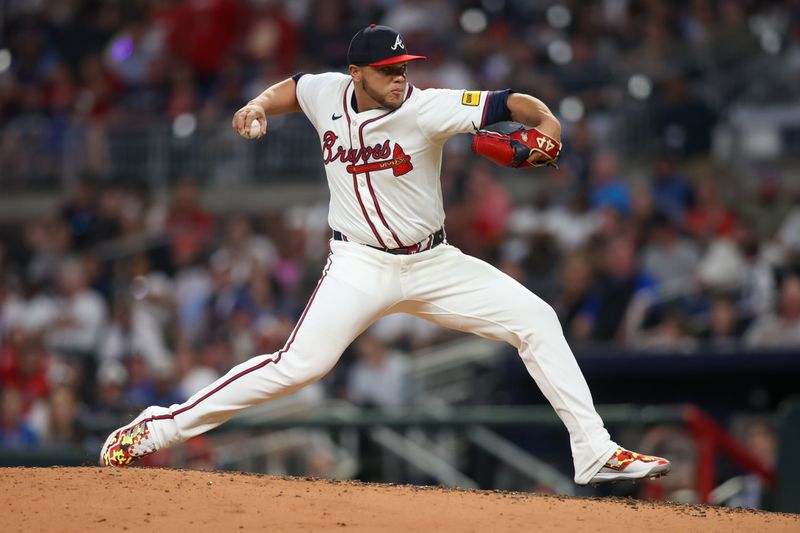 Apr 24, 2024; Atlanta, Georgia, USA; Atlanta Braves relief pitcher Joe Jimenez (77) throws against the Miami Marlins in the eighth inning at Truist Park. Mandatory Credit: Brett Davis-USA TODAY Sports
