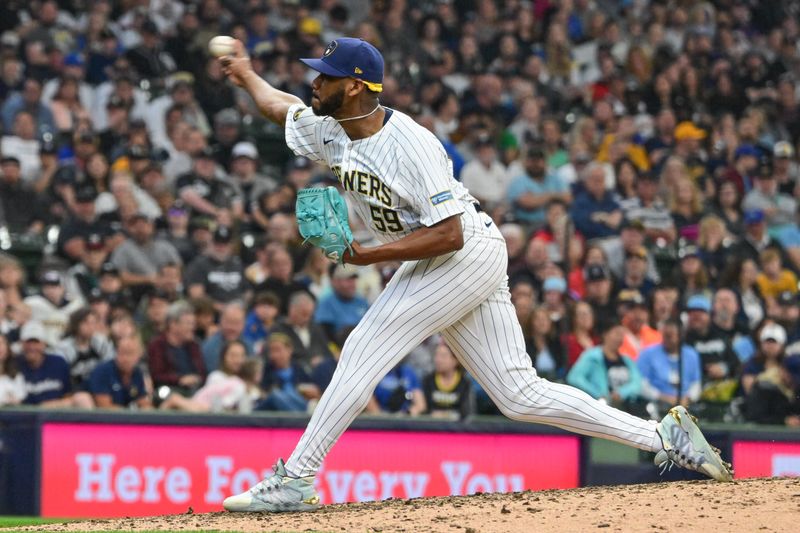 Jun 1, 2024; Milwaukee, Wisconsin, USA; Milwaukee Brewers relief pitcher Elvis Peguero (59) pitches against the Chicago White Sox in the ninth inning at American Family Field. Mandatory Credit: Benny Sieu-USA TODAY Sports