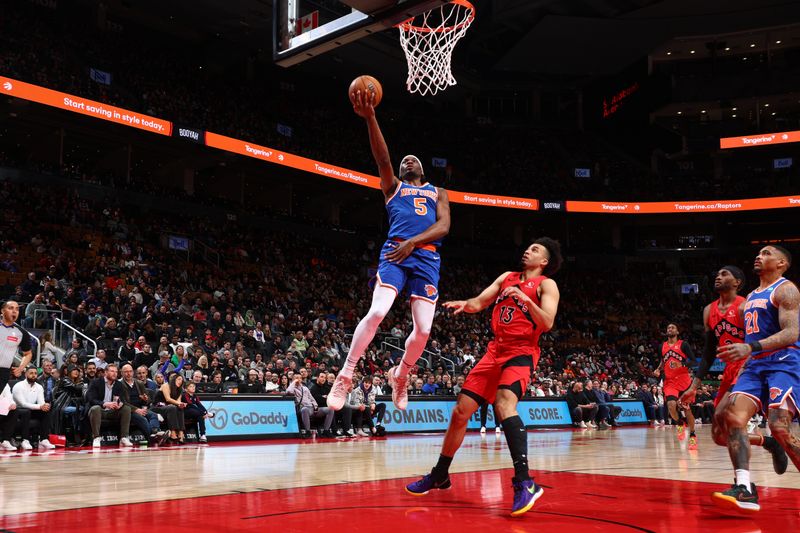 TORONTO, CANADA - MARCH 27: Precious Achiuwa #5 of the New York Knicks drives to the basket during the game against the Toronto Raptors on March 27, 2024 at the Scotiabank Arena in Toronto, Ontario, Canada.  NOTE TO USER: User expressly acknowledges and agrees that, by downloading and or using this Photograph, user is consenting to the terms and conditions of the Getty Images License Agreement.  Mandatory Copyright Notice: Copyright 2024 NBAE (Photo by Vaughn Ridley/NBAE via Getty Images)