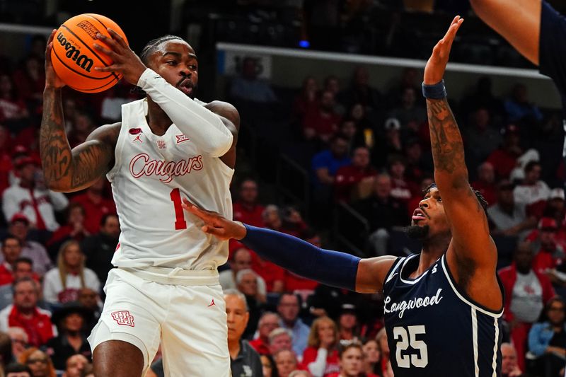 Mar 22, 2024; Memphis, TN, USA;  Houston Cougars guard Jamal Shead (1) passes the ball against Longwood Lancers forward Michael Christmas (25) during the second half in the first round of the 2024 NCAA Tournament at FedExForum. Mandatory Credit: John David Mercer-USA TODAY Sports