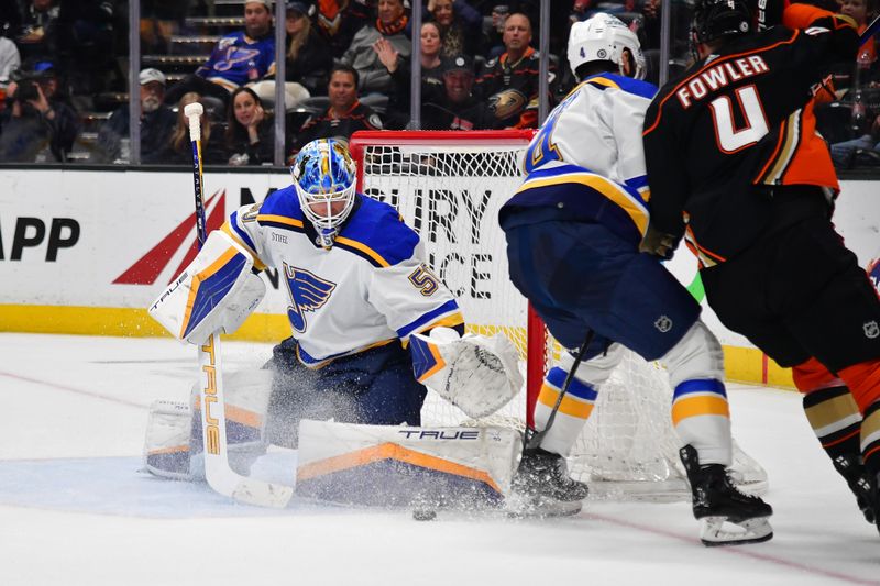 Apr 7, 2024; Anaheim, California, USA; St. Louis Blues goaltender Jordan Binnington (50) blocks a shot against Anaheim Ducks defenseman Cam Fowler (4) during the shootout at Honda Center. Mandatory Credit: Gary A. Vasquez-USA TODAY Sports