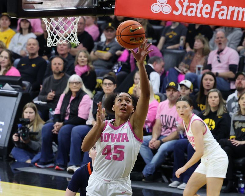 Feb 25, 2024; Iowa City, Iowa, USA; Iowa Hawkeyes forward Hannah Stuelke (45) scores against the Illinois Fighting Illini defense in the first half at Carver-Hawkeye Arena. Mandatory Credit: Reese Strickland-USA TODAY Sports